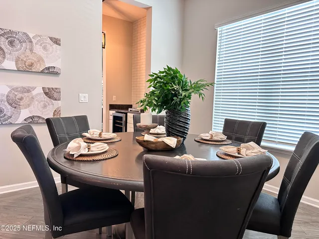 a kitchen with stainless steel appliances a sink dishwasher a stove and cabinets with wooden floor