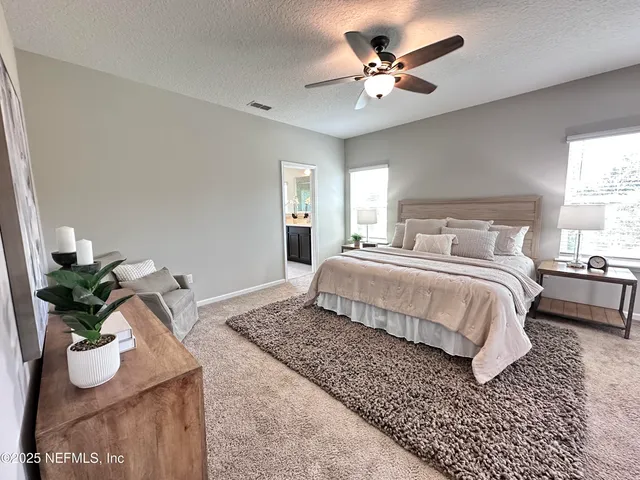 a bedroom with a large bed and a window