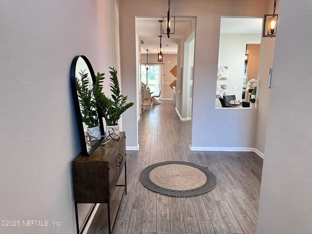 a kitchen with stainless steel appliances kitchen island granite countertop a stove a sink and white cabinets