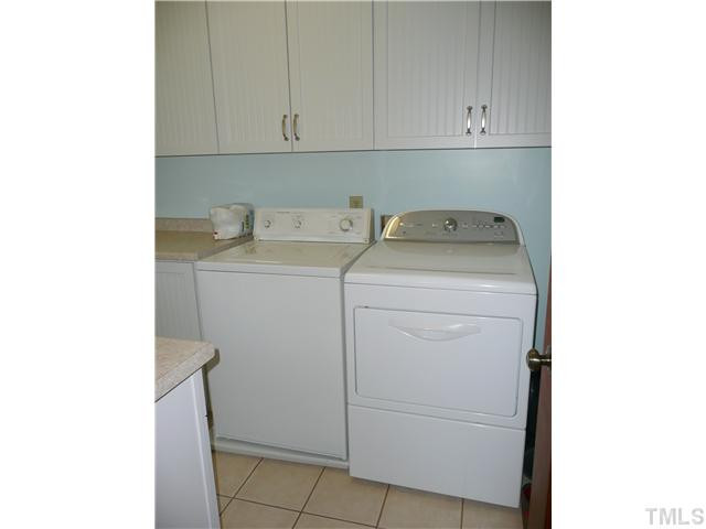 10300 Whitestone Road Raleigh, NC 27615 - Photo 10 of 25 Fabulous first floor laundry room with tile floor and lots of storage. Laundry Room