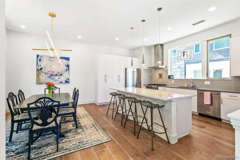 a kitchen with stainless steel appliances granite countertop a stove a sink and a refrigerator