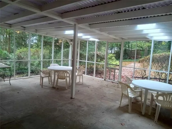 a view of a patio with table and chairs