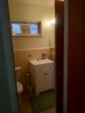 a bed sitting in a kitchen next to a window
