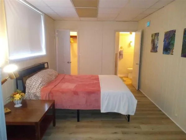 a bedroom with a bed and a table