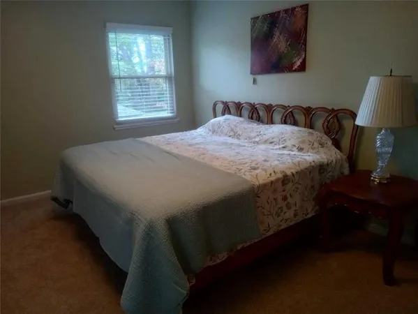 a bed sitting in a bedroom next to a window
