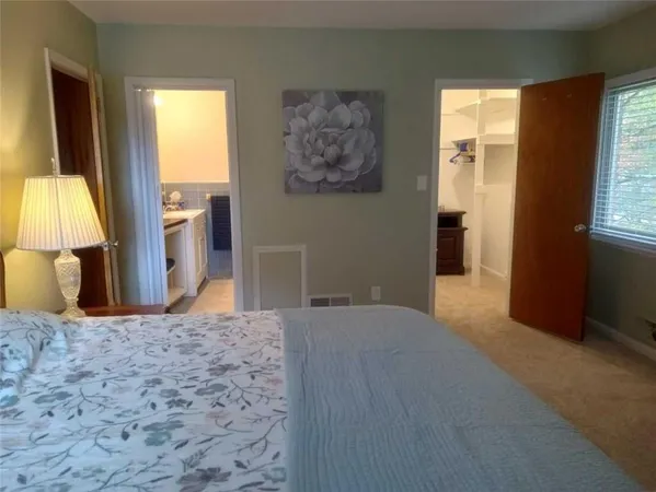 a view of a bedroom with a large bed and a window