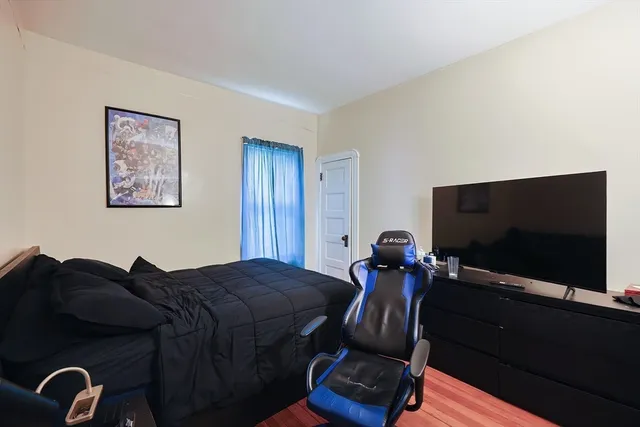 a bedroom with a bed and a flat screen tv