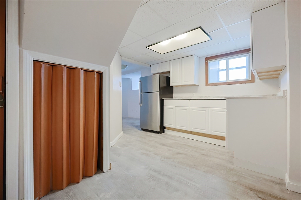105 16th Street Fall River, MA 02723 - Photo 21 of 31 a view of a kitchen with refrigerator and window