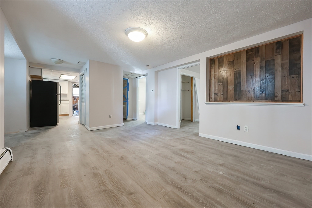 105 16th Street Fall River, MA 02723 - Photo 23 of 31 a view of an empty room with wooden floor and windows