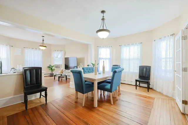 a view of a dining room with furniture window and wooden floor