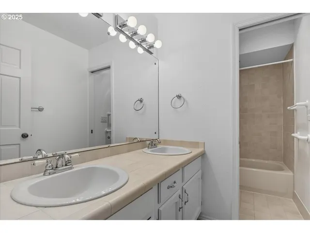 a backyard of a house with table and chairs plants