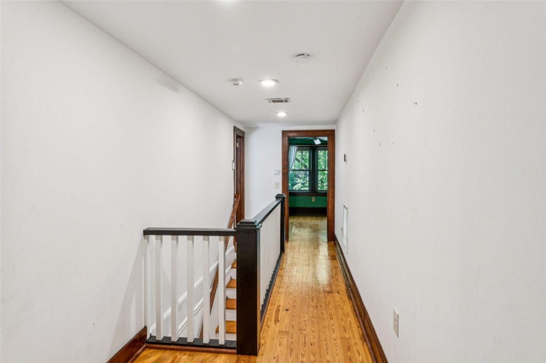 321 South Pine Street Walhalla, SC 29691 - Photo 21 of 32 A classic staircase with warm hardwood flooring defines this inviting upper-level hallway.