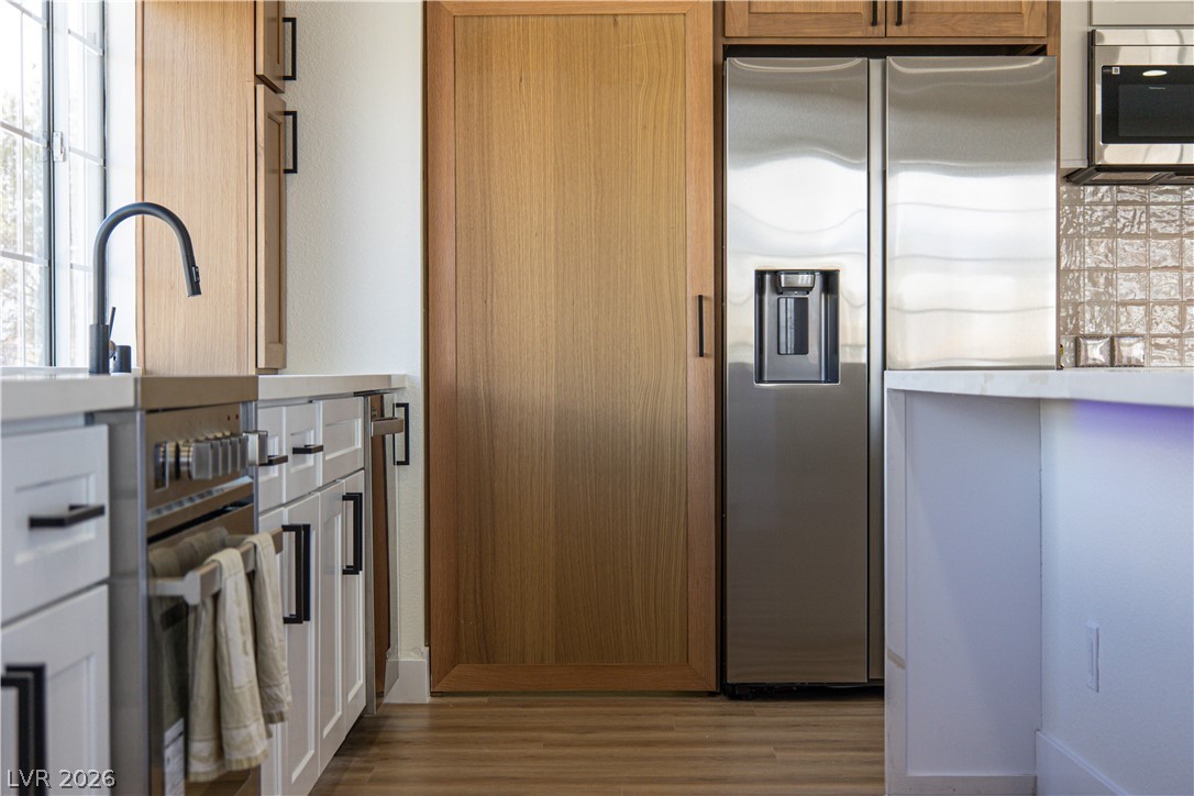1891 Brian Road Pahrump, NV 89048 - Photo 9 of 50 Kitchen featuring appliances with stainless steel finishes and wood finished floors