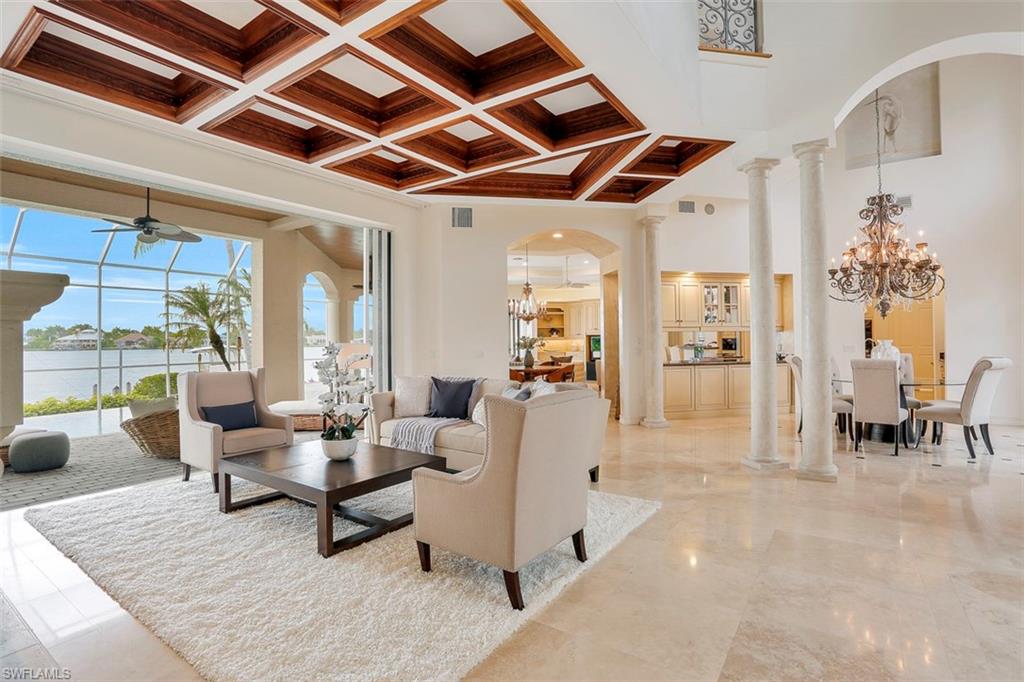 2050 Kingfish Road Naples, FL 34102 - Photo 11 of 35 a living room with furniture and a dining table