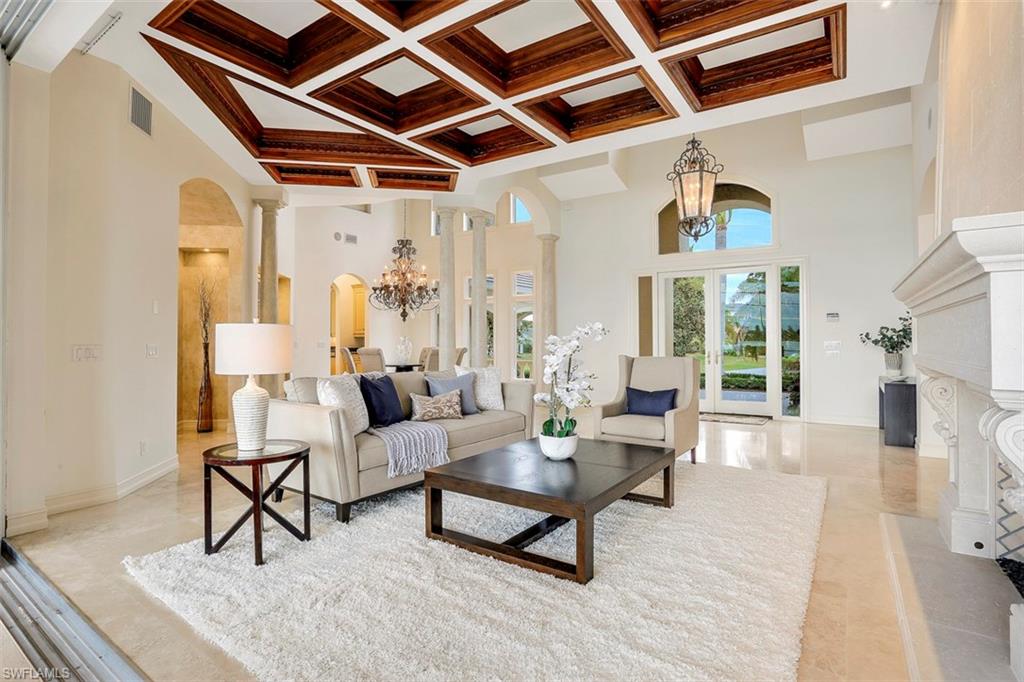 2050 Kingfish Road Naples, FL 34102 - Photo 12 of 35 a living room with furniture and a chandelier