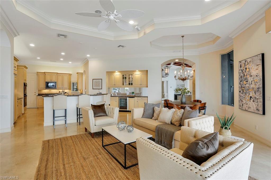 2050 Kingfish Road Naples, FL 34102 - Photo 16 of 35 a living room with furniture kitchen view and a wooden floor