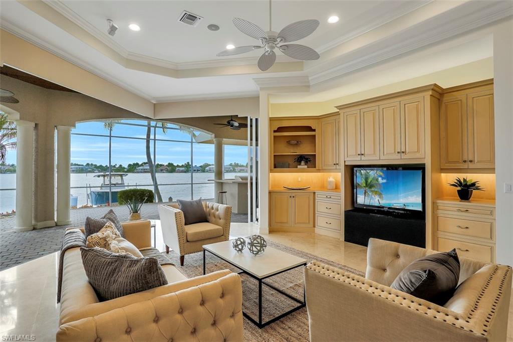 2050 Kingfish Road Naples, FL 34102 - Photo 17 of 35 a living room with furniture and a fireplace