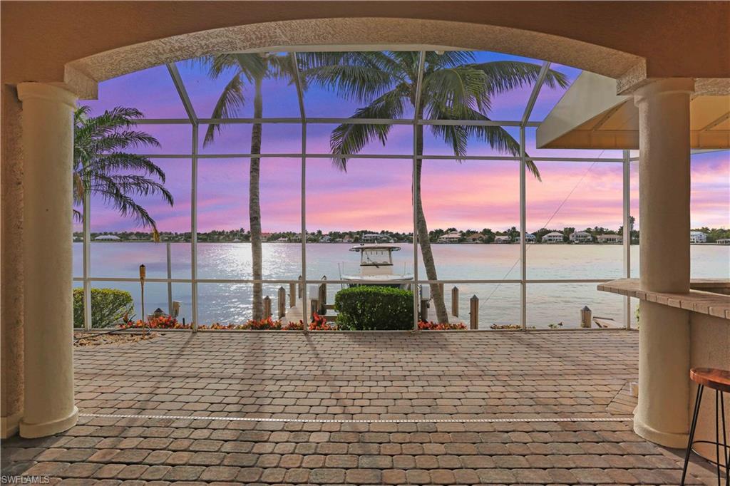 2050 Kingfish Road Naples, FL 34102 - Photo 2 of 35 a view of a terrace with seating space