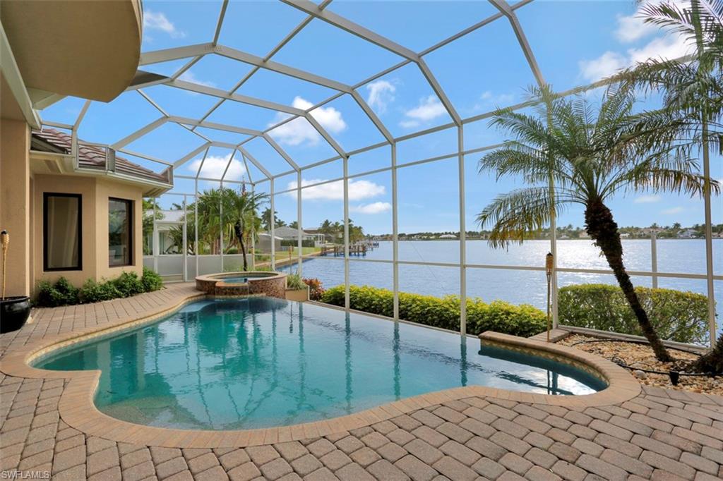 2050 Kingfish Road Naples, FL 34102 - Photo 22 of 35 a view of a swimming pool with a patio