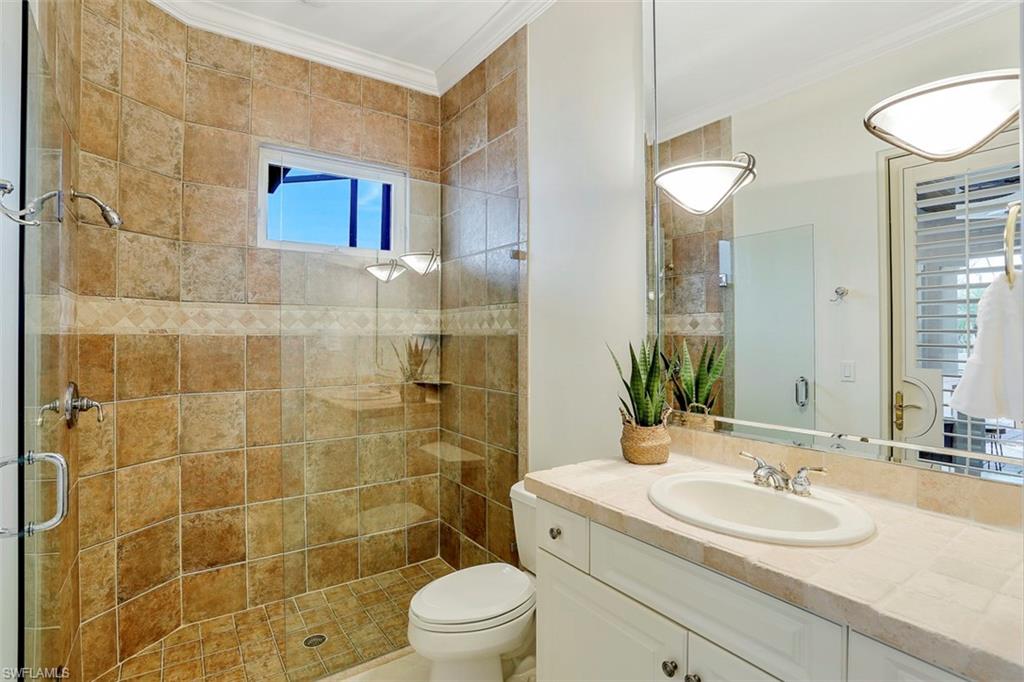 2050 Kingfish Road Naples, FL 34102 - Photo 28 of 35 a bathroom with a sink a toilet and shower