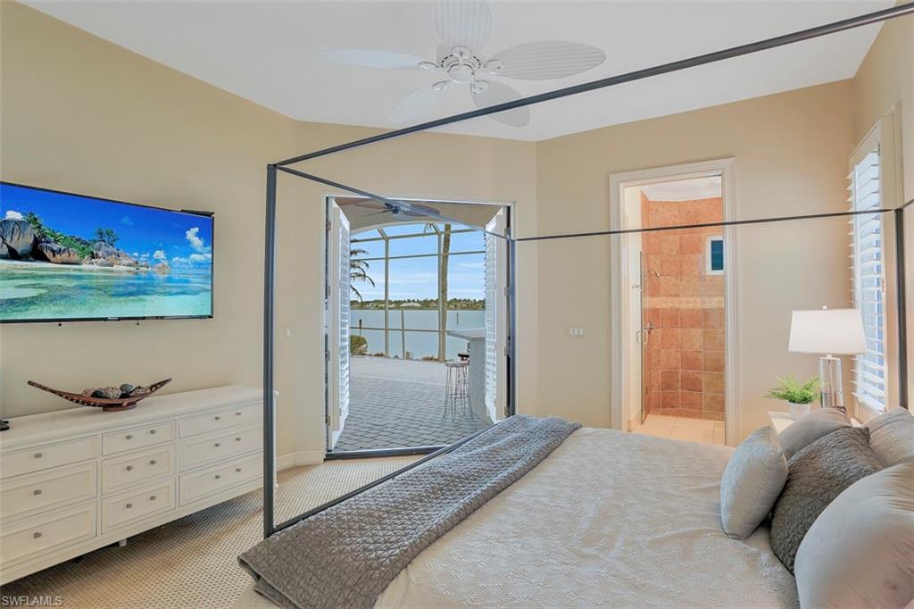 2050 Kingfish Road Naples, FL 34102 - Photo 29 of 35 a bedroom with a bed and a dresser in it
