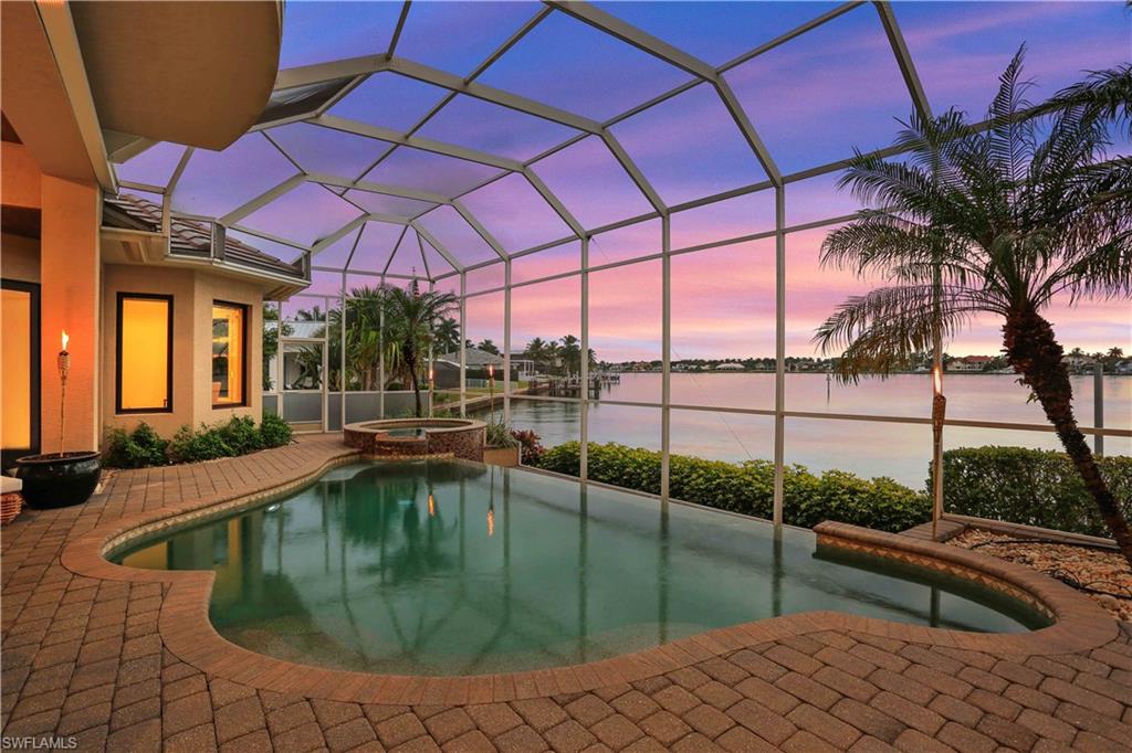 2050 Kingfish Road Naples, FL 34102 - Photo 3 of 35 a swimming pool with outdoor seating