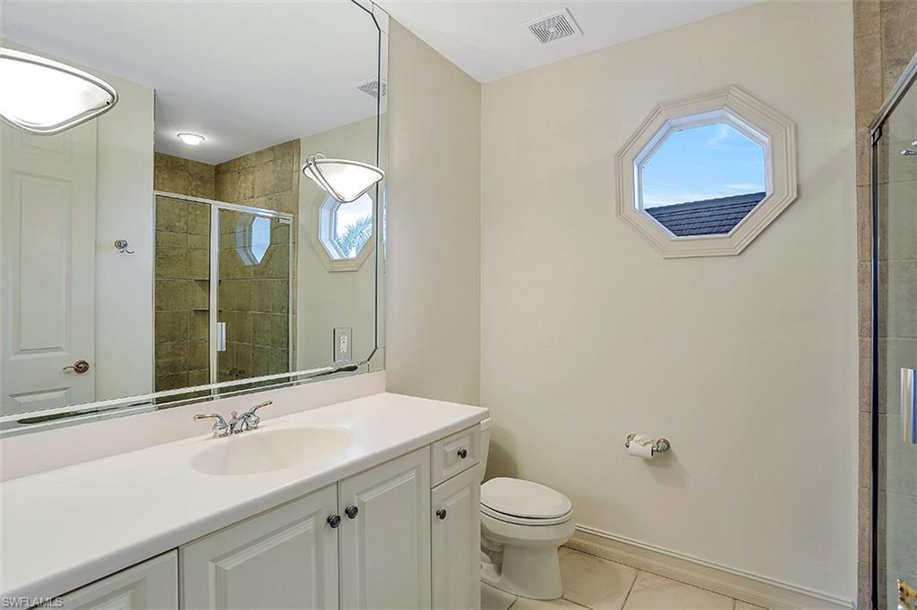 2050 Kingfish Road Naples, FL 34102 - Photo 31 of 35 a bathroom with a sink and a mirror