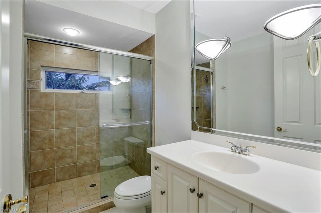 2050 Kingfish Road Naples, FL 34102 - Photo 35 of 35 a bathroom with a sink and a mirror