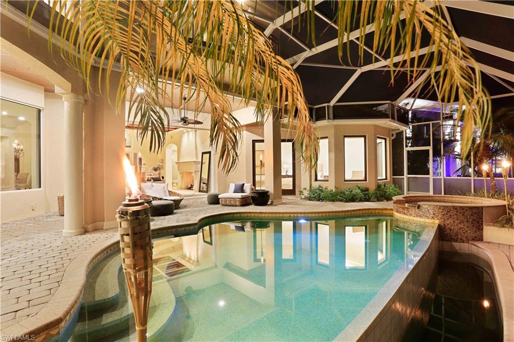 2050 Kingfish Road Naples, FL 34102 - Photo 6 of 35 a view of a swimming pool with outdoor seating