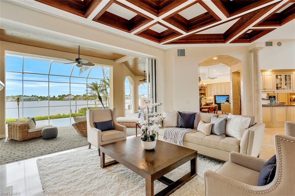 2050 Kingfish Road Naples, FL 34102 - Photo 10 of 35 a living room with furniture and floor to ceiling windows