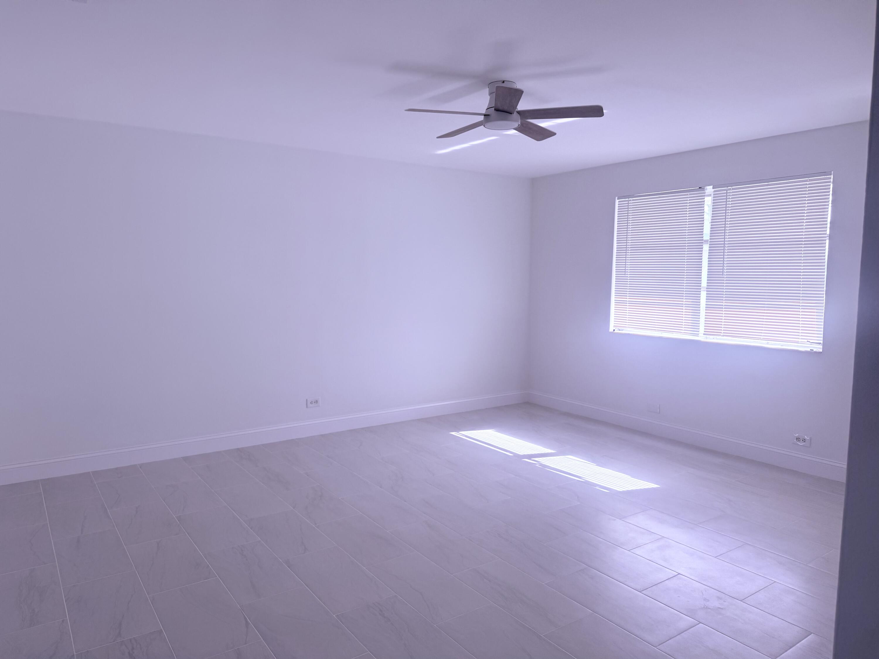 630 Prosperity Farms Road, Unit 1 North Palm Beach, FL 33408 - Photo 4 of 16 a view of an empty room with a window