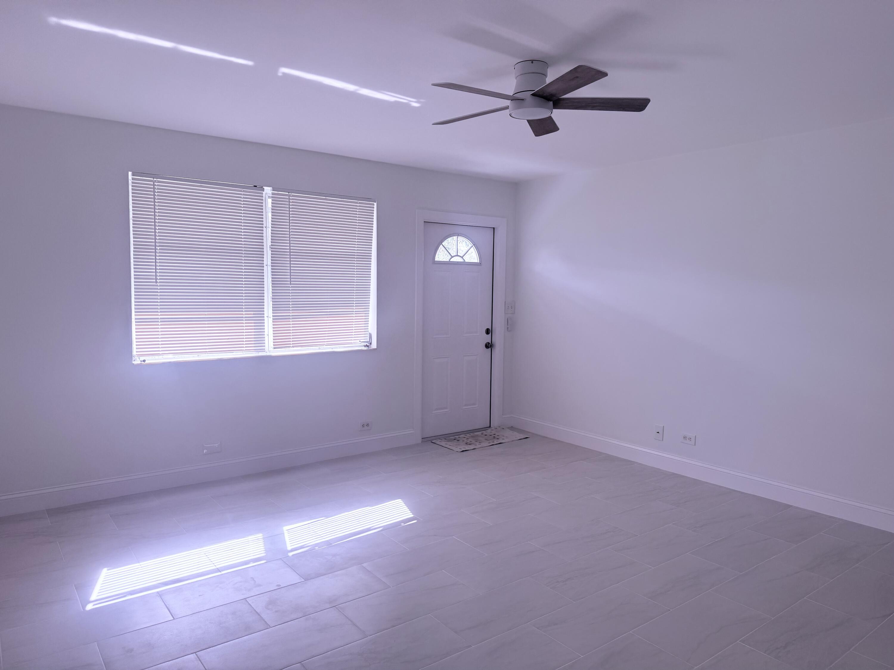 630 Prosperity Farms Road, Unit 1 North Palm Beach, FL 33408 - Photo 5 of 16 a view of an empty room with a window