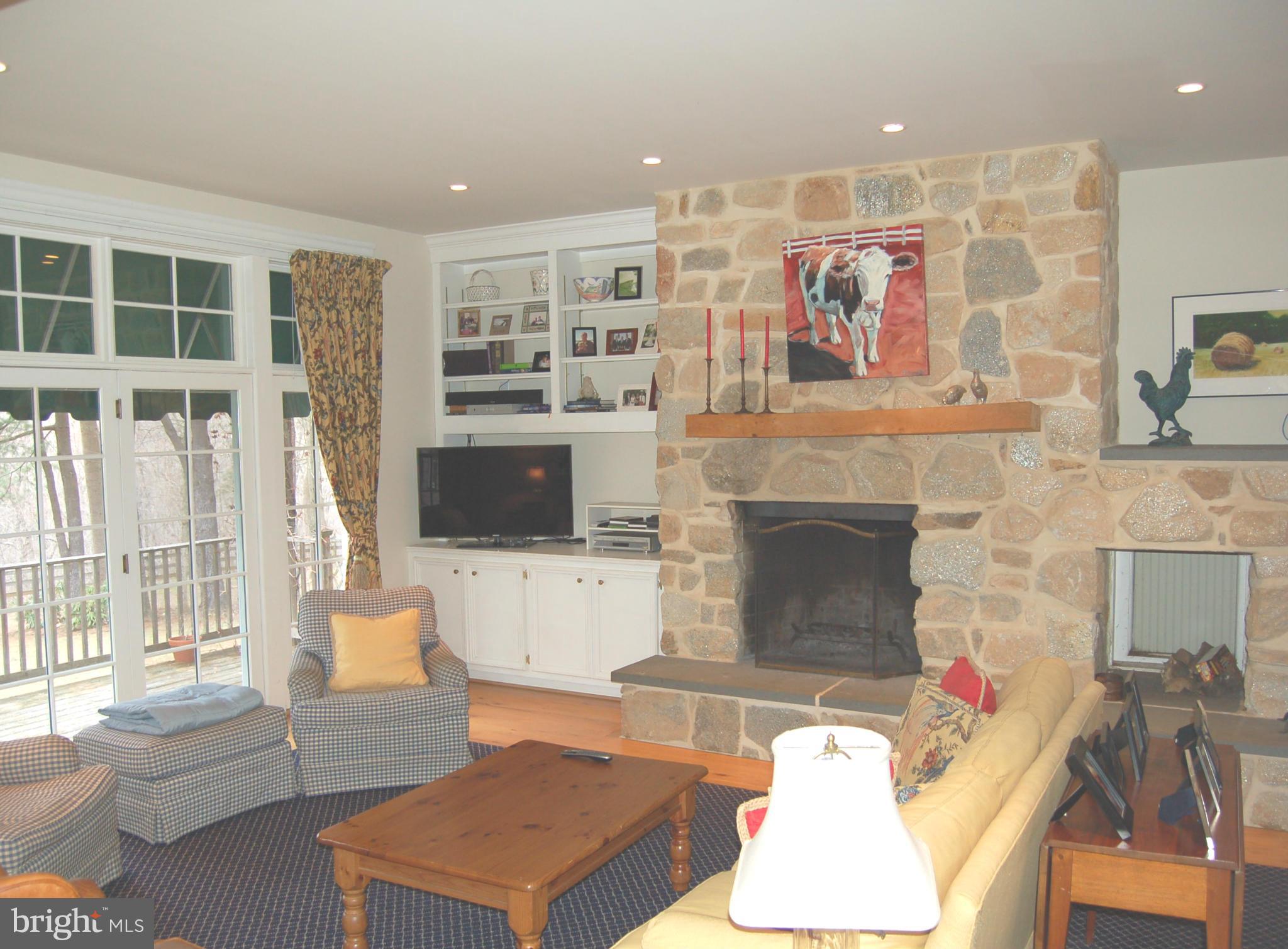 2312 Monkton Road Monkton, MD 21111 - Photo 4 of 30 a living room with furniture a flat screen tv and a fireplace