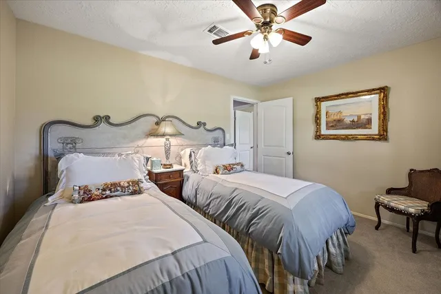 a bedroom with two beds and a chandelier