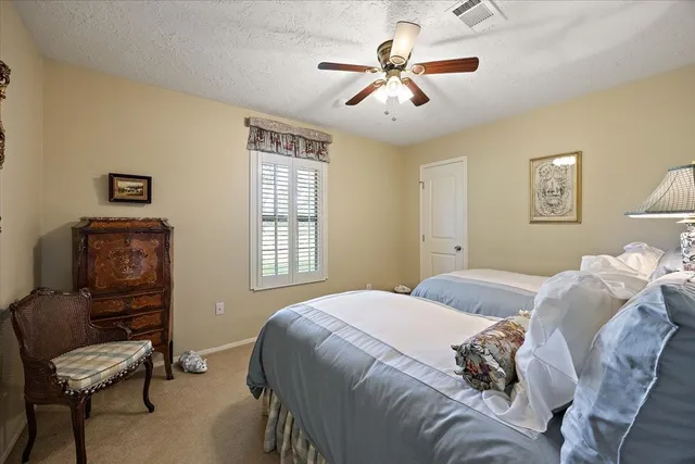 a bedroom with a bed and a chair