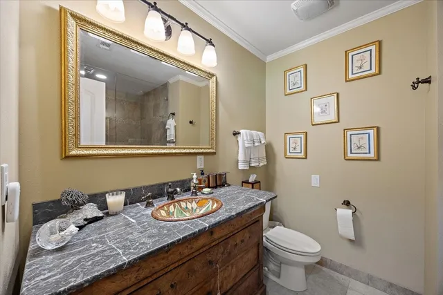 a bathroom with a granite countertop toilet sink and mirror