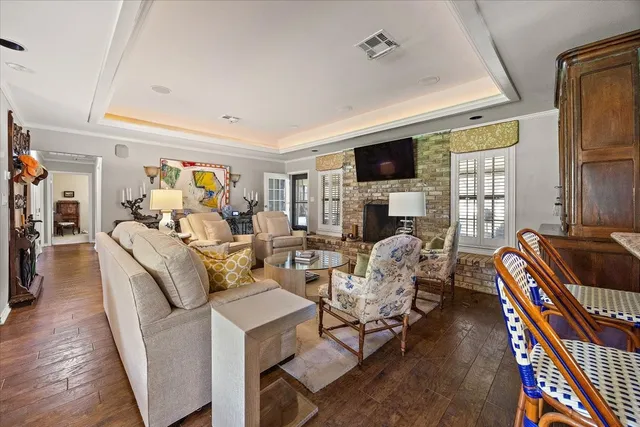 a living room with fireplace furniture and a flat screen tv