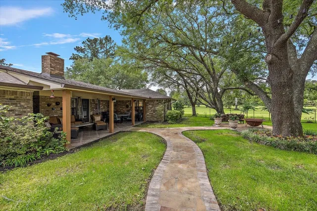 a view of a house with a yard and sitting area