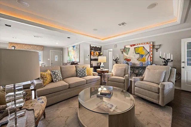 a living room with furniture and painting on the wall