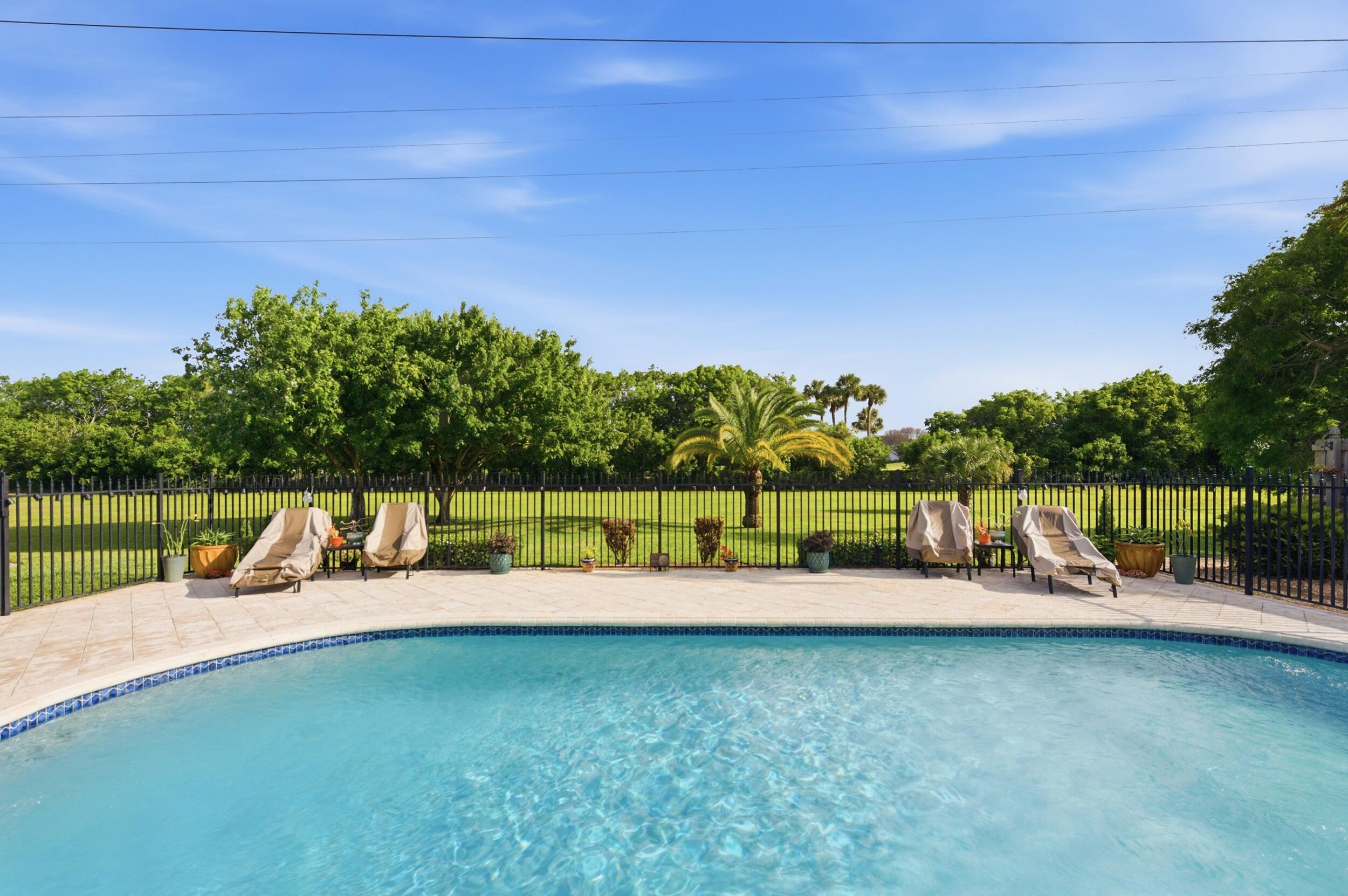 4780 Brandywine Drive Boca Raton, FL 33487 - Photo 28 of 43 a view of a swimming pool with a yard