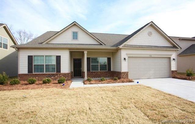 a front view of a house with a yard and porch