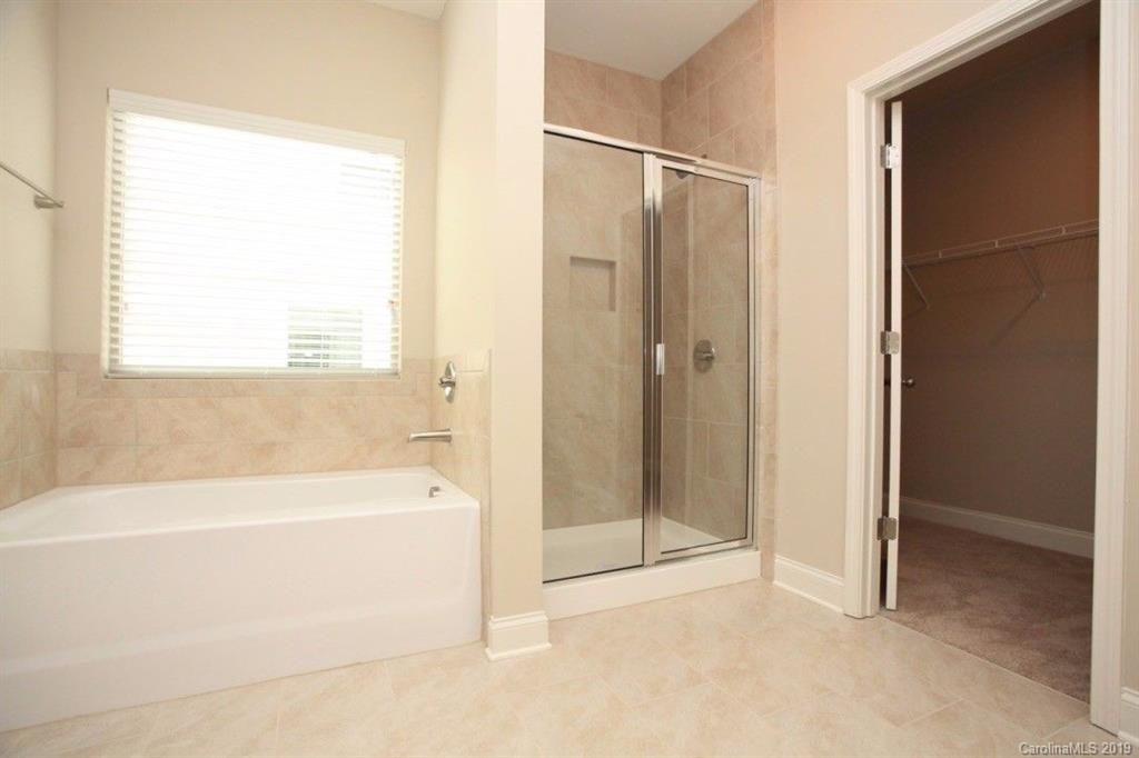 5326 Roberta Road Concord, NC 28027 - Photo 2 of 6 a bathroom with a bathtub and a shower