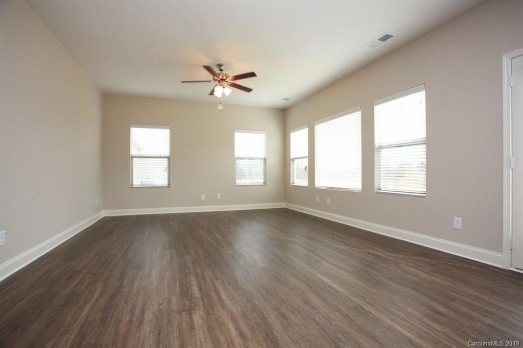 5326 Roberta Road Concord, NC 28027 - Photo 4 of 6 a view of an empty room with wooden floor and a window