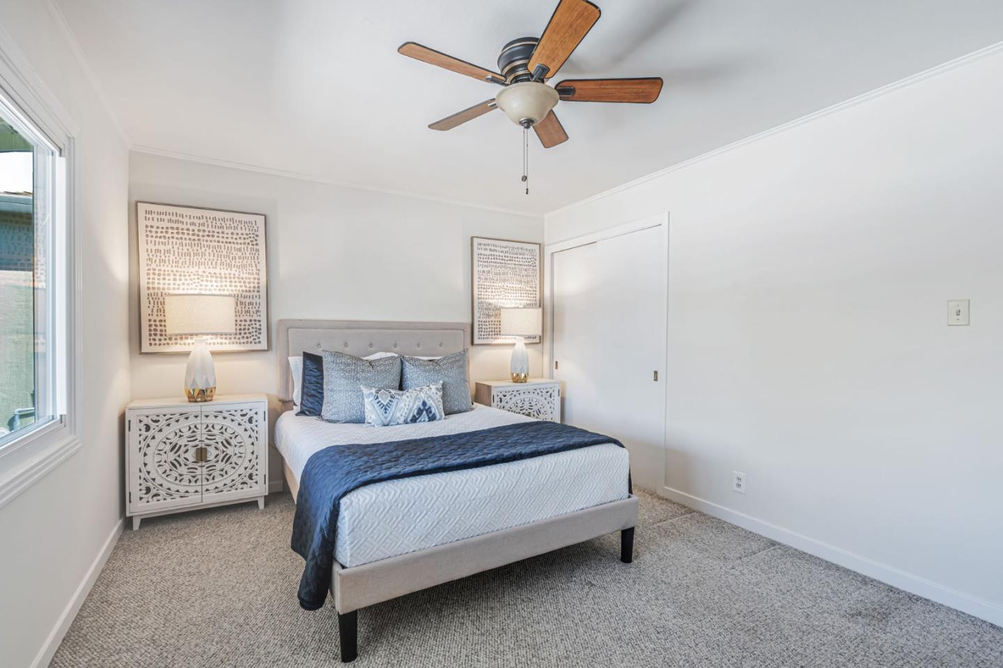 3993 Pasadena Drive San Mateo, CA 94403 - Photo 19 of 40 a bedroom with a bed chandelier and a window