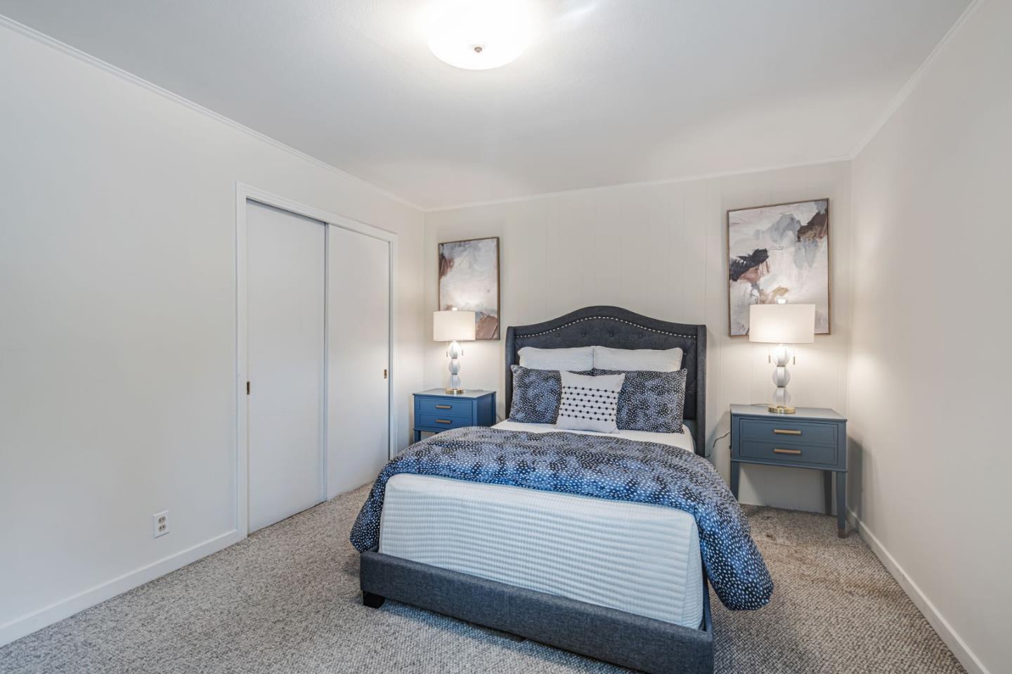 3993 Pasadena Drive San Mateo, CA 94403 - Photo 27 of 40 a bedroom with a bed and lamp