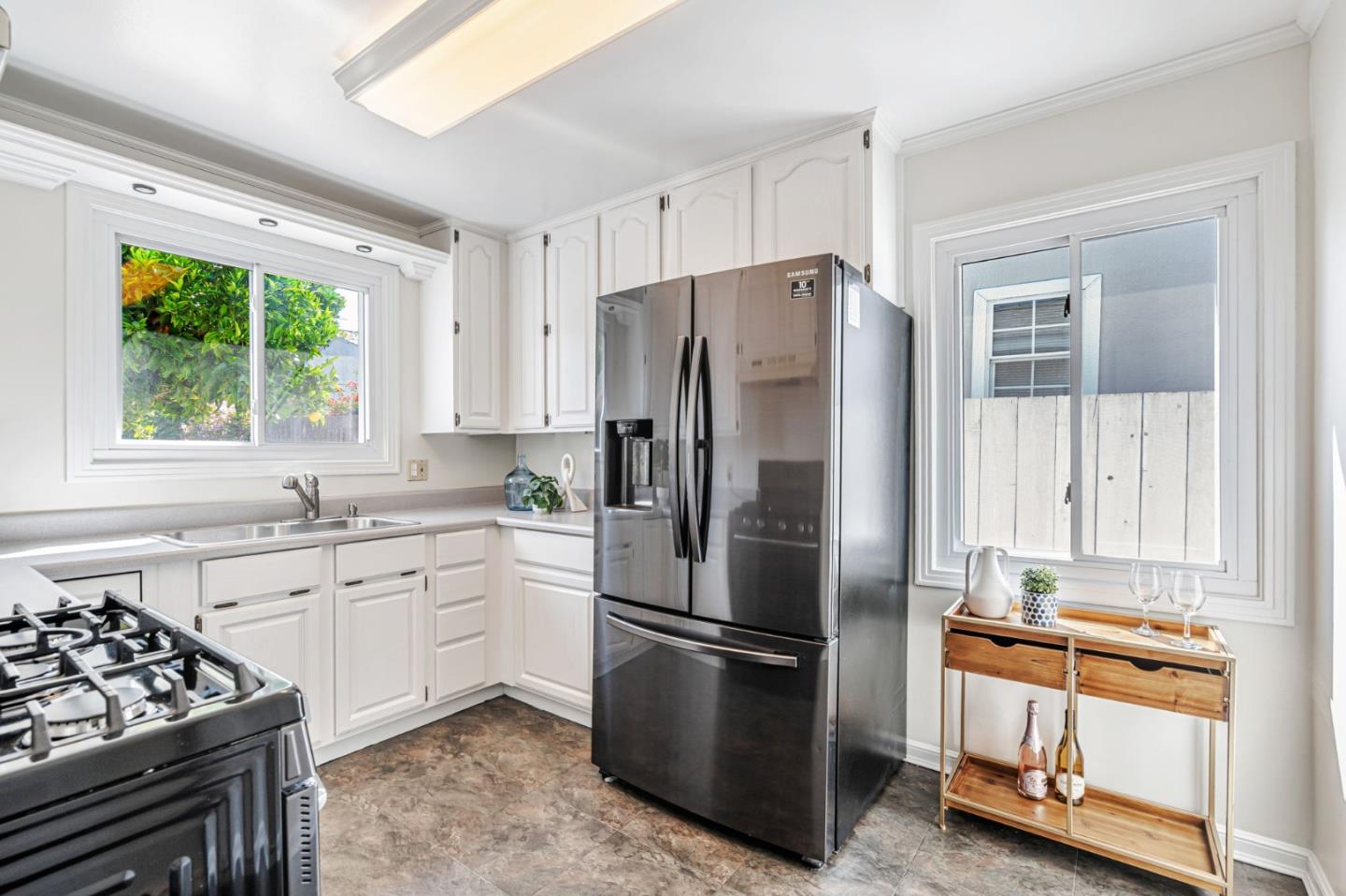 3993 Pasadena Drive San Mateo, CA 94403 - Photo 10 of 40 a kitchen with stainless steel appliances a refrigerator sink and stove