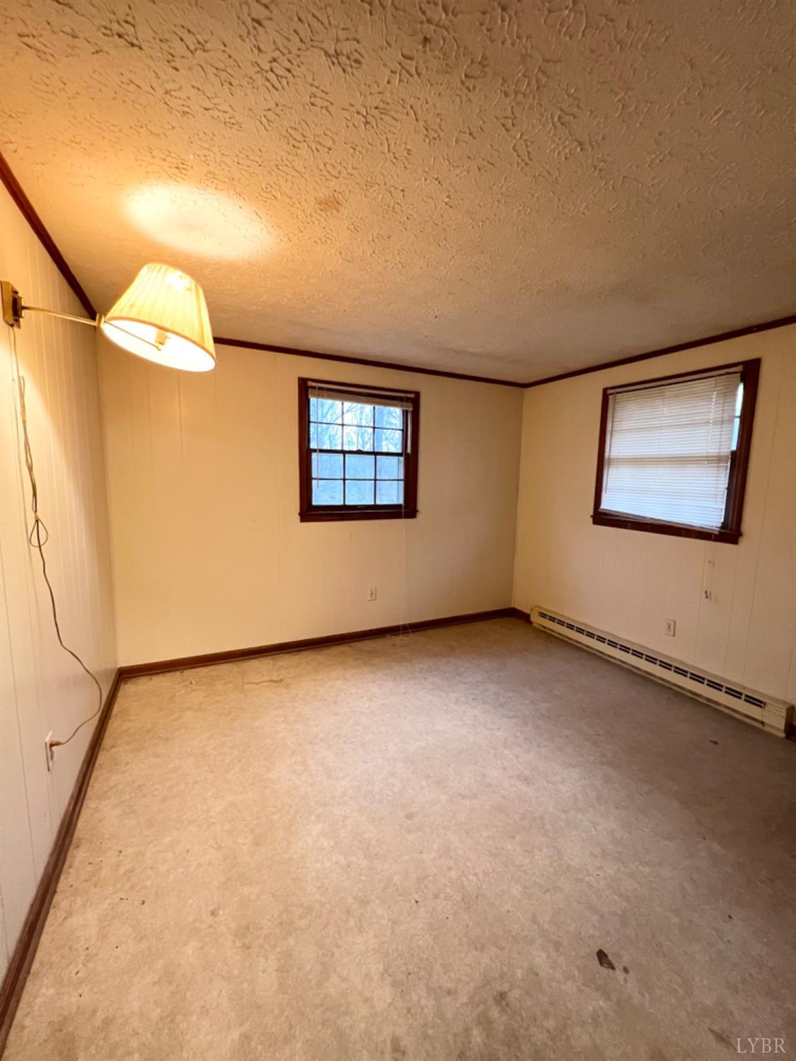 1266 Ambrose Rucker Road Monroe, VA 24574 - Photo 9 of 18 a view of an empty room with a window