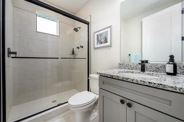 a bathroom with a toilet a sink and a mirror