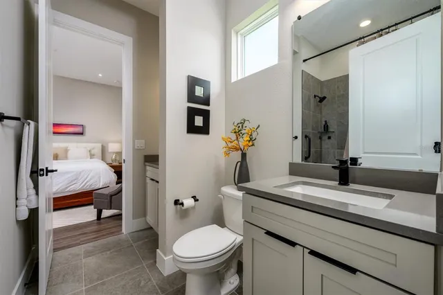 a kitchen with a dining table chairs and refrigerator