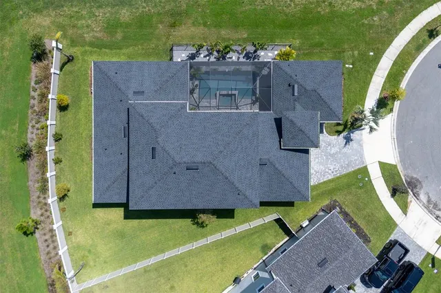 a front view of a house with a yard and potted plants